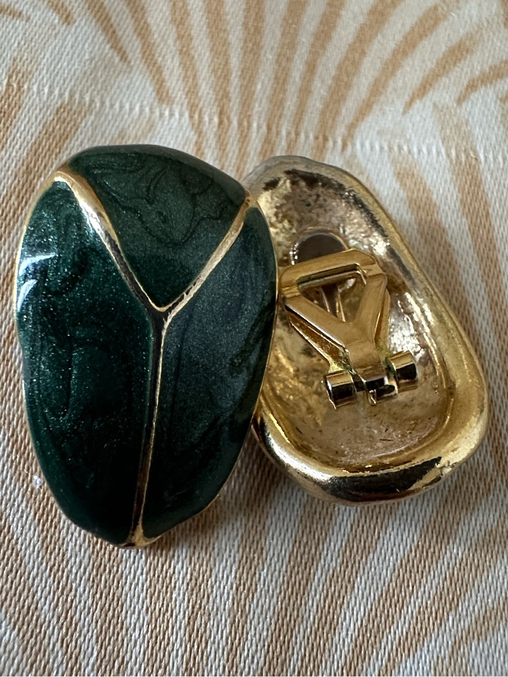Vintage 80 gold-tone clip-on earrings featuring a dark green enamel beetle desig